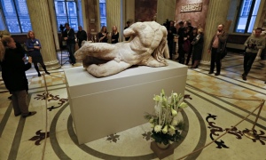 Visitors look at a sculpture from the Parthenon marbles at the Hermitage in St Petersburg, Russia